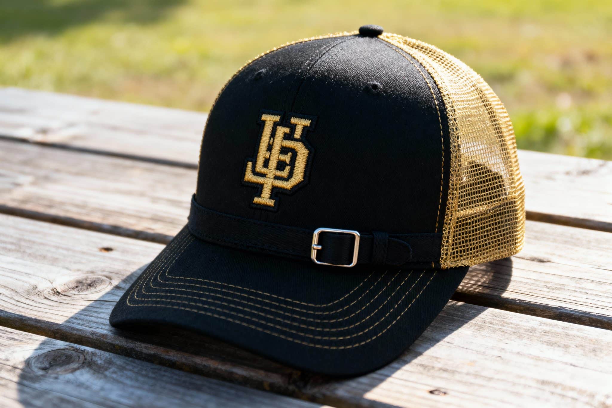 black and gold trucker hat